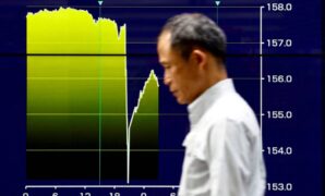An electronic screen displays a graph showing Japanese yen exchange rates surging against the U.S. dollar amid signs of intervention by authorities, in Tokyo on Thursday.